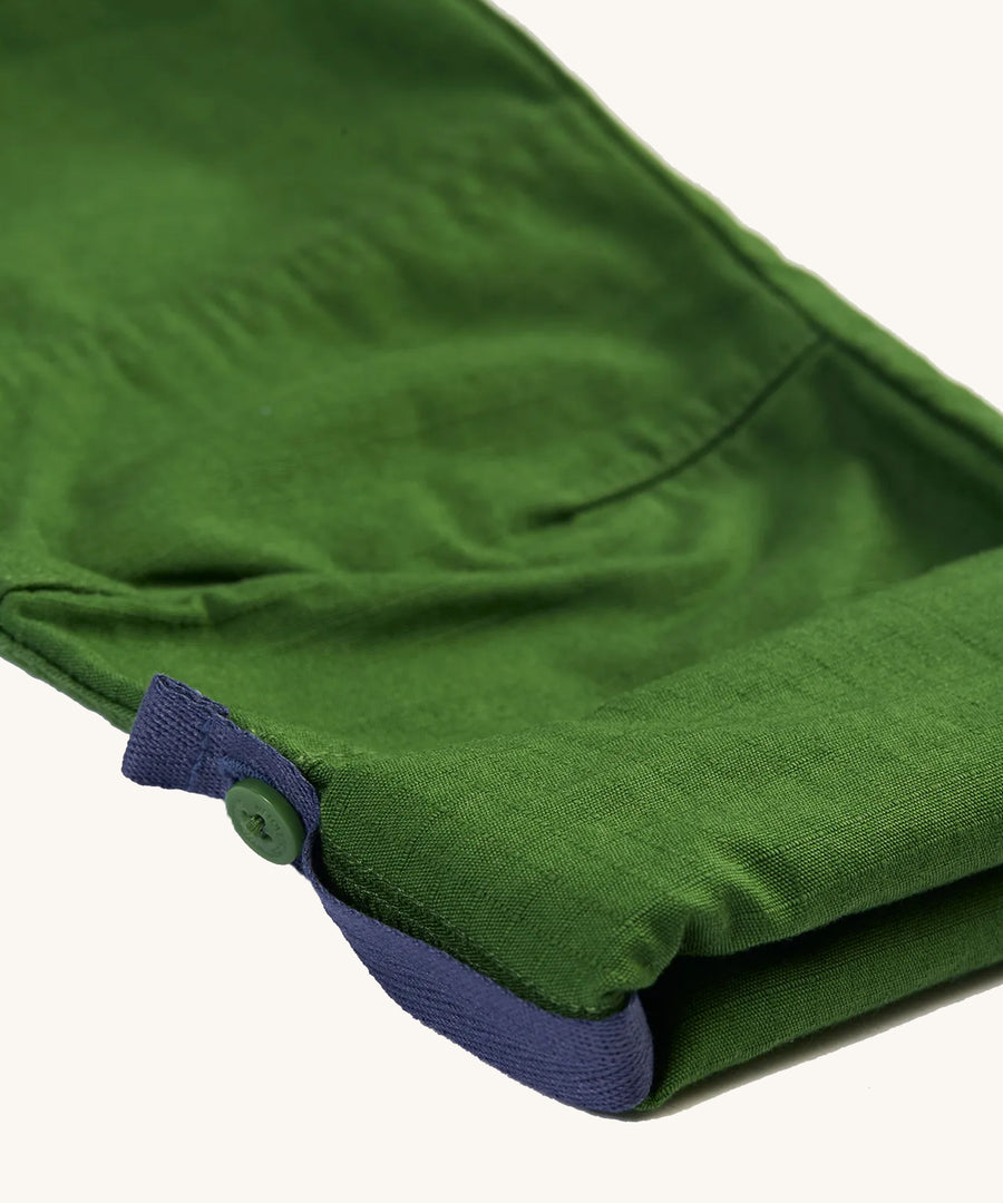 A closer view of the adjustable leg and leg strap on the Frugi Pioneer Trousers - Jungle Green