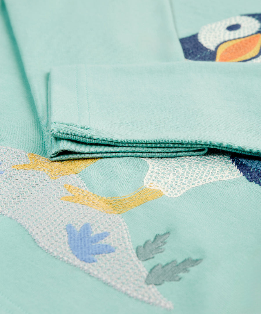 A closer look at the sleeves and embroidered puffin on the Frugi Adventure Embroidered Top - Moss/Puffin Stitch