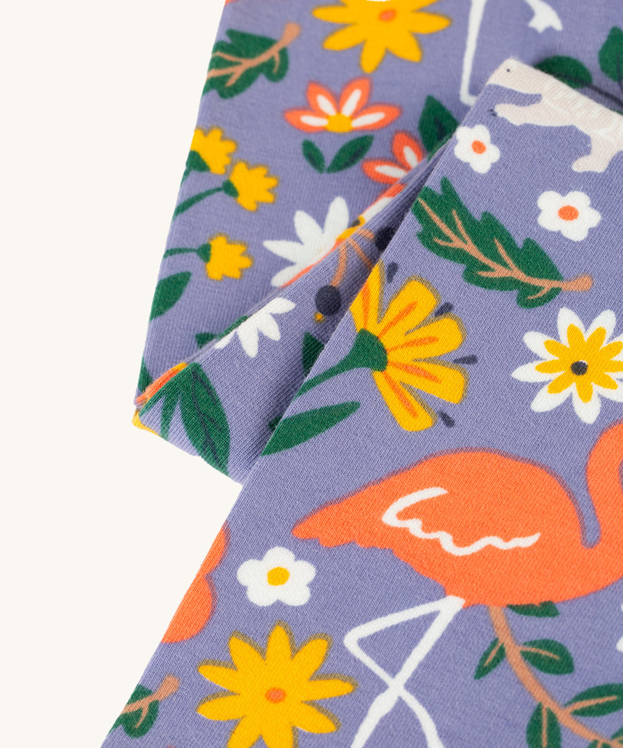 A closer look at the print on the Frugi Libby Printed Leggings - Rainforest Friends. The print has zebras, flamingos, parrots, and more wild friends print.