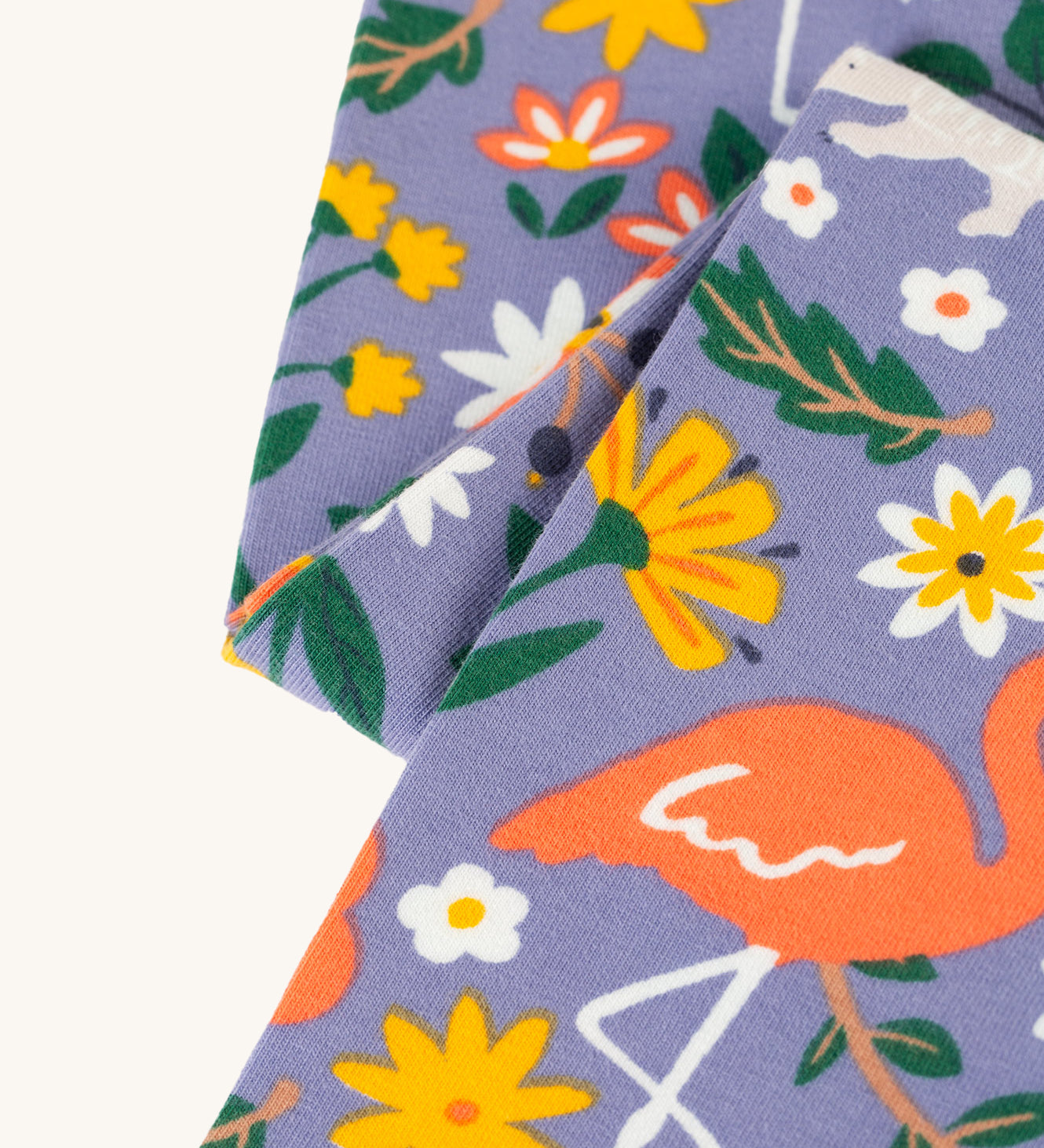 A closer look at the print on the Frugi Libby Printed Leggings - Rainforest Friends. The print has zebras, flamingos, parrots, and more wild friends print.