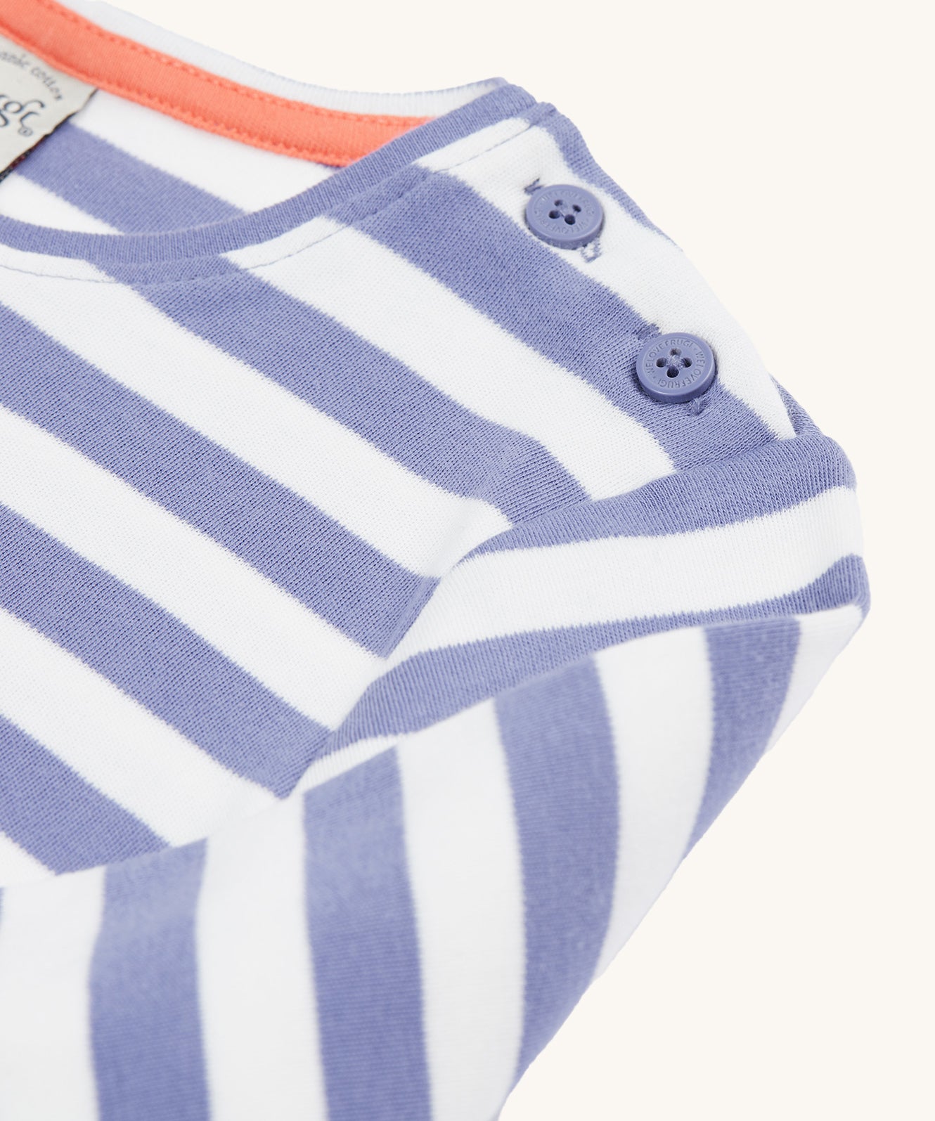 A closer look at the shoulder on the Frugi Louise Applique Top - Grape Stripe/Rainbow. The image shows the shoulder buttons, and the lilac and white stripes on the top