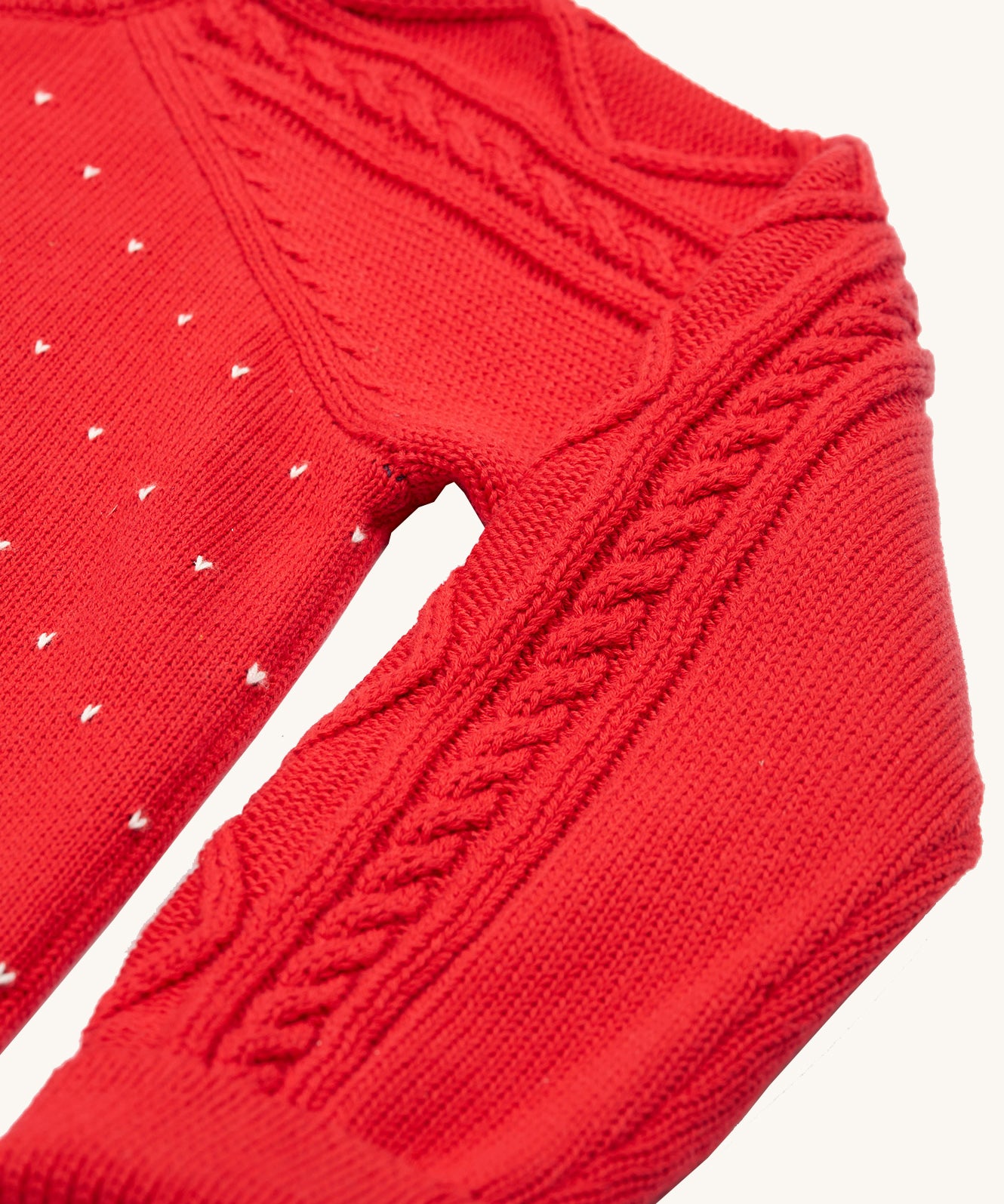 A closer look at the cable knit sleeve detail on the Caleb Character Knit Jumper - True Red/Penguin