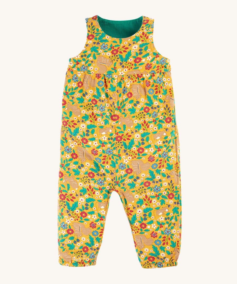 Frugi Lacey Reversible Dungaree - Iguana/Autumn Friends in a yellow floral rabbit and squirrel print