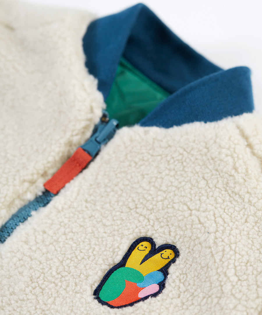 A closer look at the fleece side of the Frugi Robin Reversible Quilted Jacket - Teal/Moon