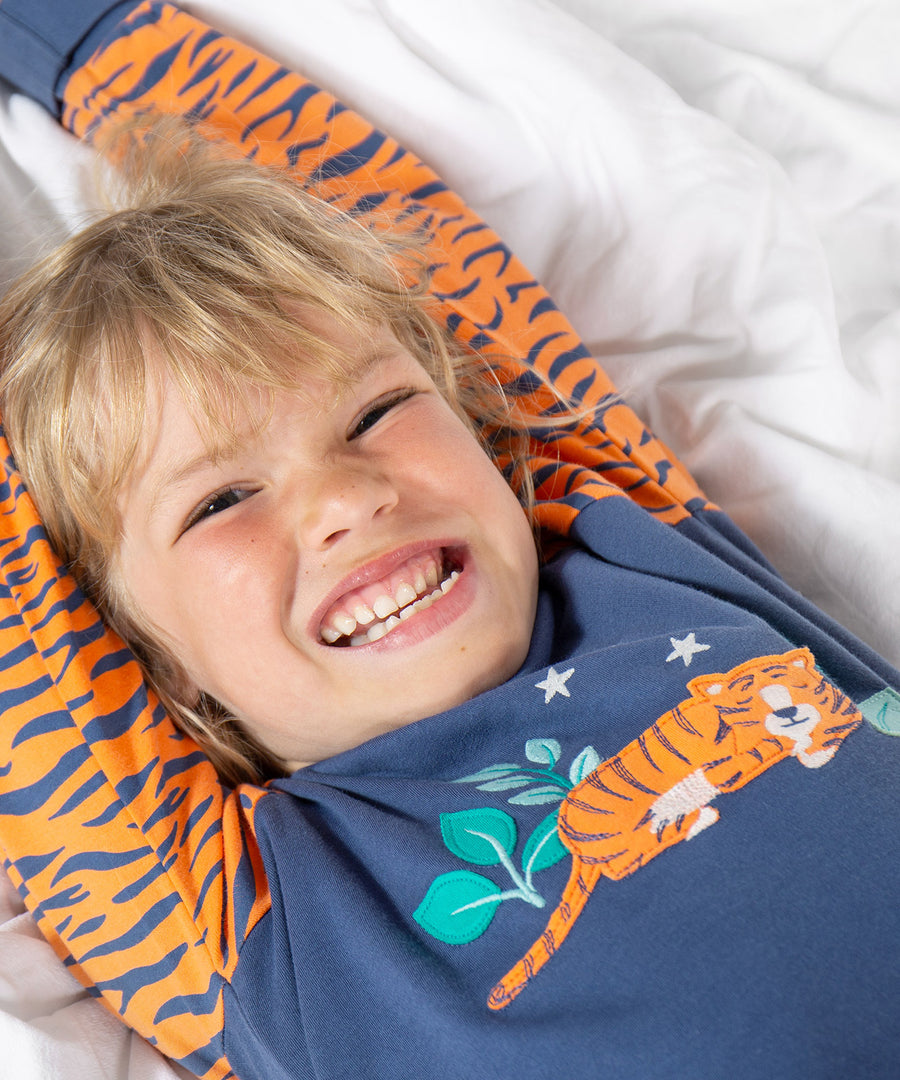 A child wearing the Frugi Jamie Jim Jams - Sleeping Tiger