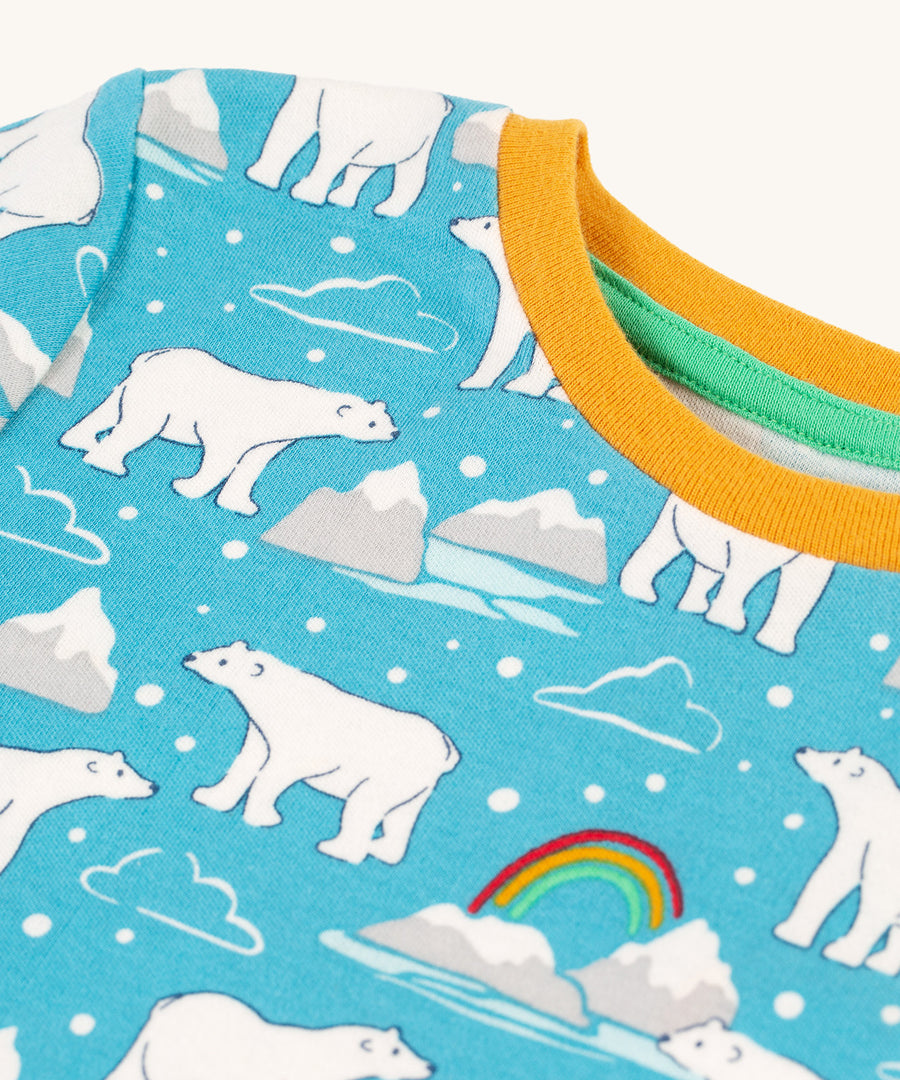 A close up of the yellow collar detail on the Frugi Sundown Pyjamas - Winter Tales top, which matches perfect with the light blue fabric, with polar bears, icebergs and rainbow print.