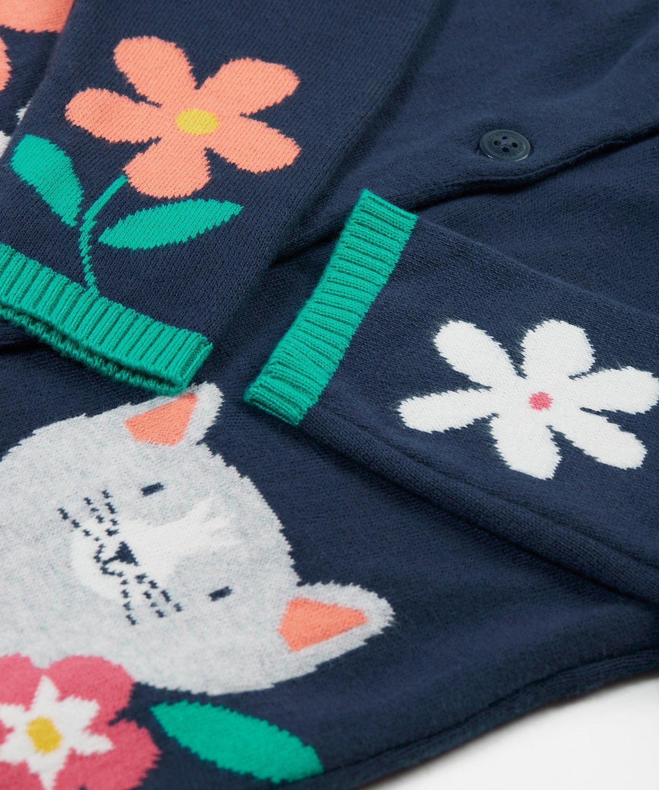 A closer look at the flower and cat detail on the body and sleeves of the Frugi Reva Knitted Cardigan - Navy Blue/Cat