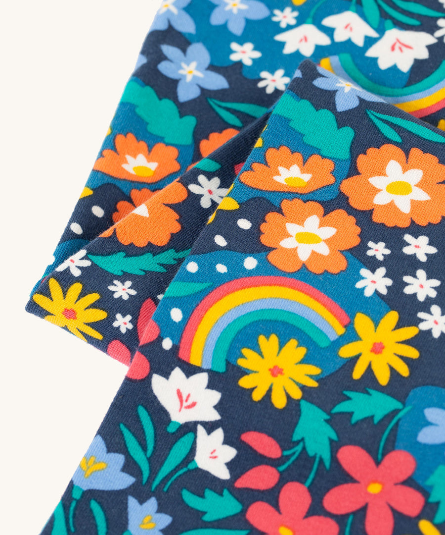 A closer look at the floral and rainbow print on the Frugi Libby Leggings - Winter Hedgerow