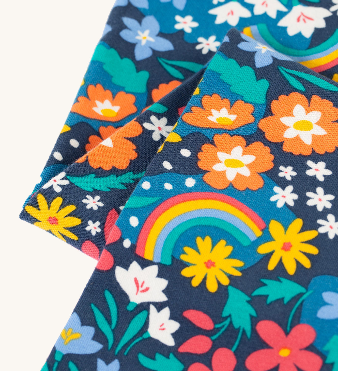 A closer look at the floral and rainbow print on the Frugi Libby Leggings - Winter Hedgerow