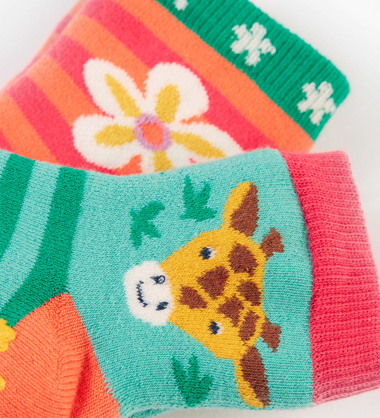 A closer look at the the giraffe and flower print on the Frugi Grippy Socks 2 Pack - Giraffe