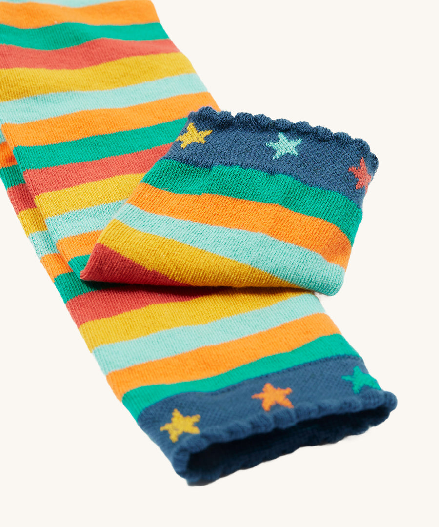 A closer look at the angle cuffs on teh Frugi Little Knitted Leggings - Rainbow Stripe/Tractor, with colourful stars and striped legs