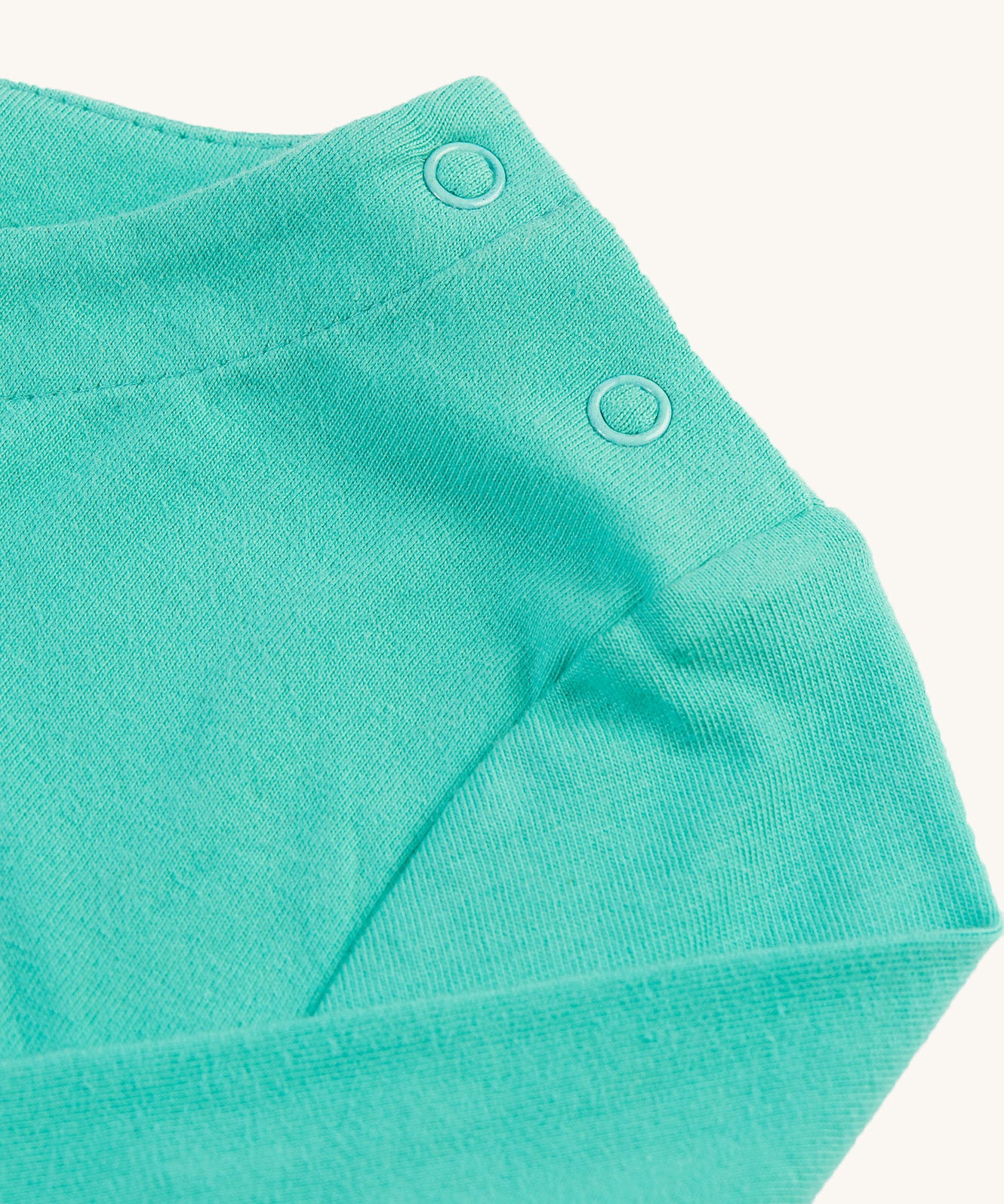 The shoulder popper fasteners on the Frugi Anna Applique Top - Pacific Aqua/Horse