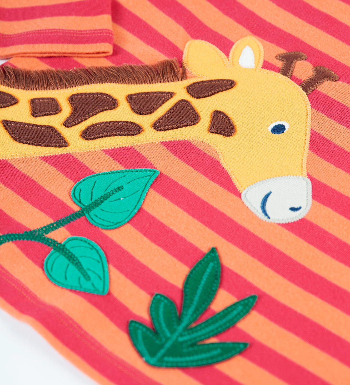 A closer look at the giraffe and leaf applique on the Frugi Bobby Applique Top - Cantaloupe Stripe/Giraffe