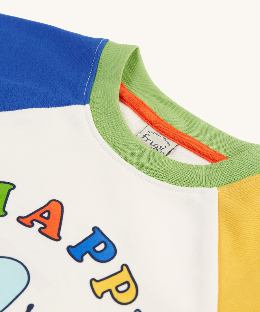 A closer look at the green collar and the tops of the sleeves on the Frugi Tamar Raglan Top - Soft White/Bee Happy. The Bee and Bee Happy print can be slightly seen at the bottom of the image