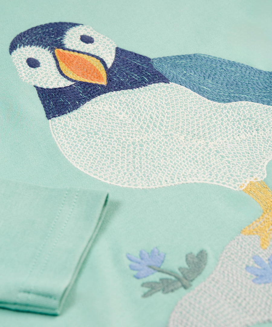 The detail of the embroidered Frugi puffin on the Frugi Adventure Embroidered Top - Moss/Puffin Stitch 