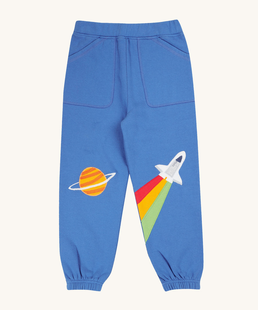 Frugi Malpas Applique Joggers - Blue Tang/Rocket. Lovely blue, organic cotton jogging bottoms with a fun planet and rocket applique patch on each knee.