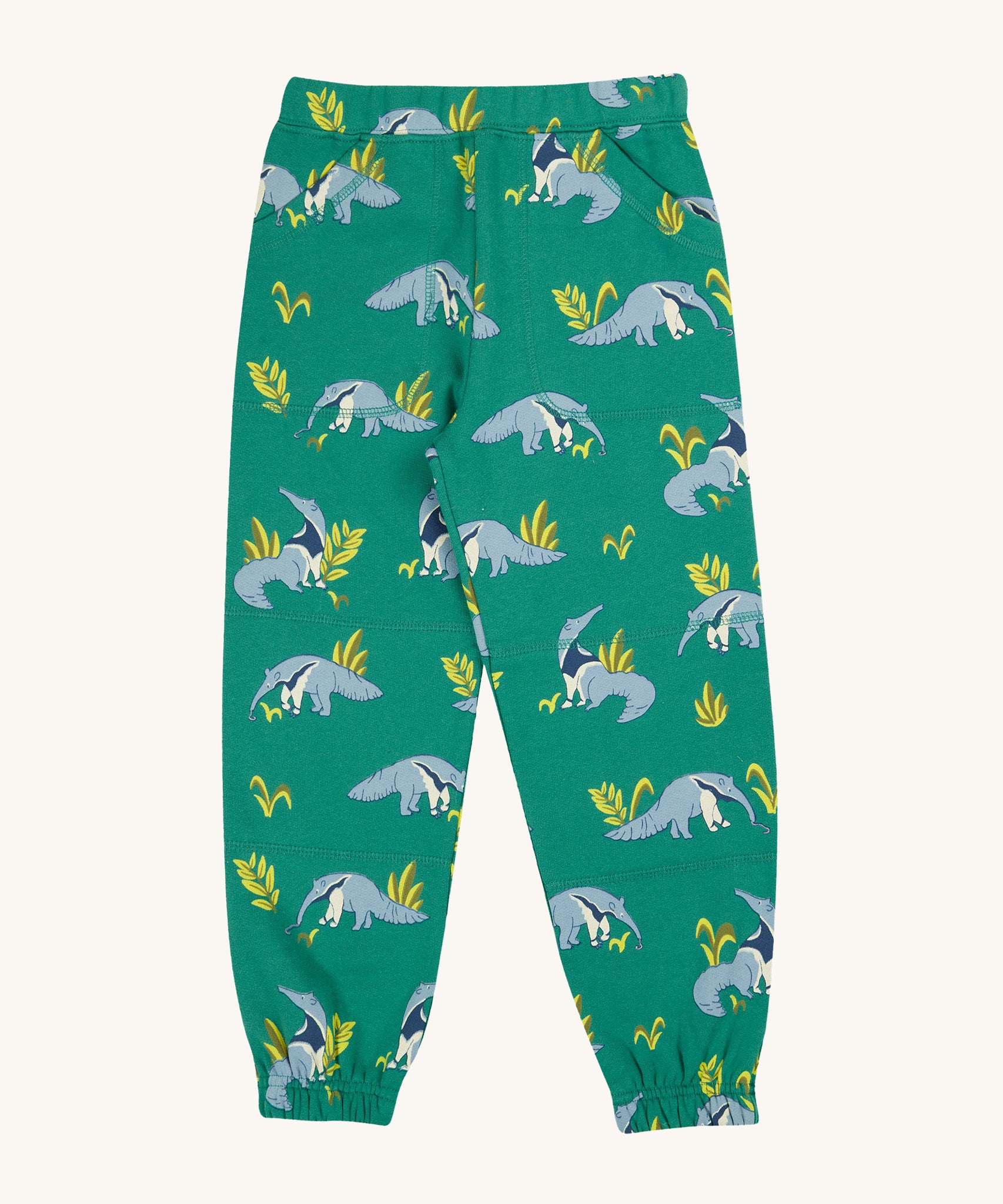 Frugi Malpas Joggers - Anteater Parade. These joggers are in green fabric with a repeat anteater and leaf print. They also have an elasticated waist, ankle cuffs and pockets