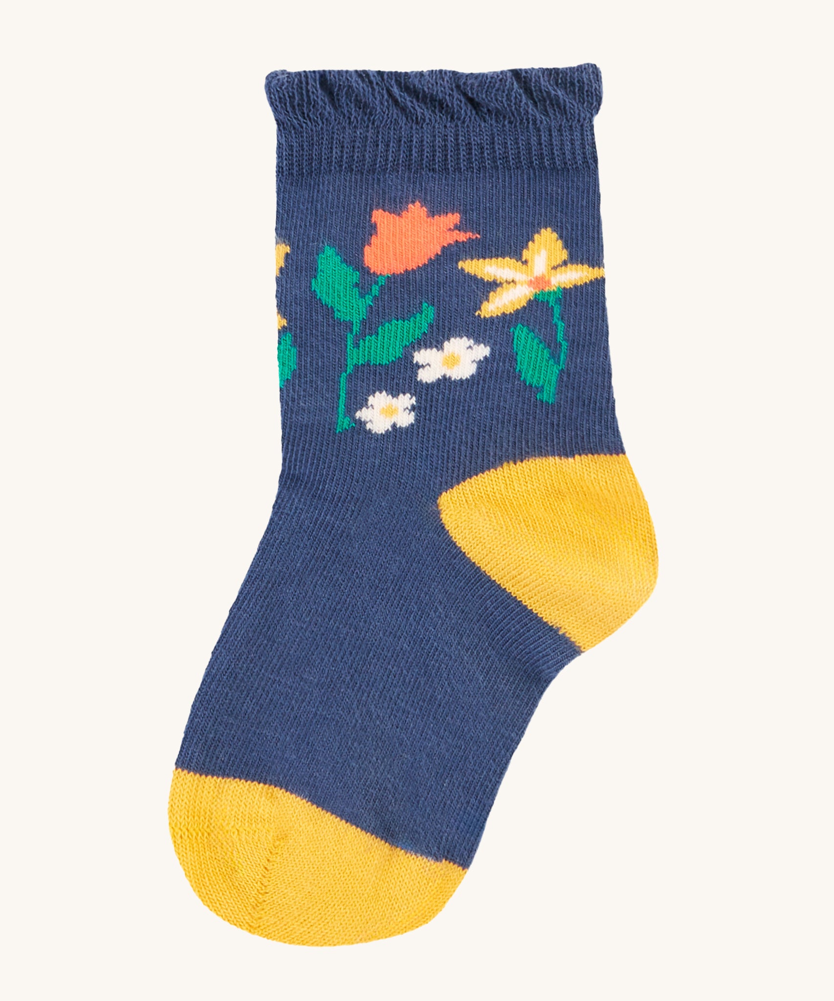 The navy blue socks from the Frugi Freya Frilled Socks 3 Pack - Rainforest Friends. This sock has a yellow toe and heel, with colourful flowers in a navy blue fabric