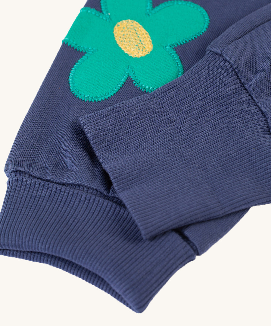 A look at the adjustable ankle cuffs on the Frugi Perrin Parsnip Jogger - Navy Blue/Flowers