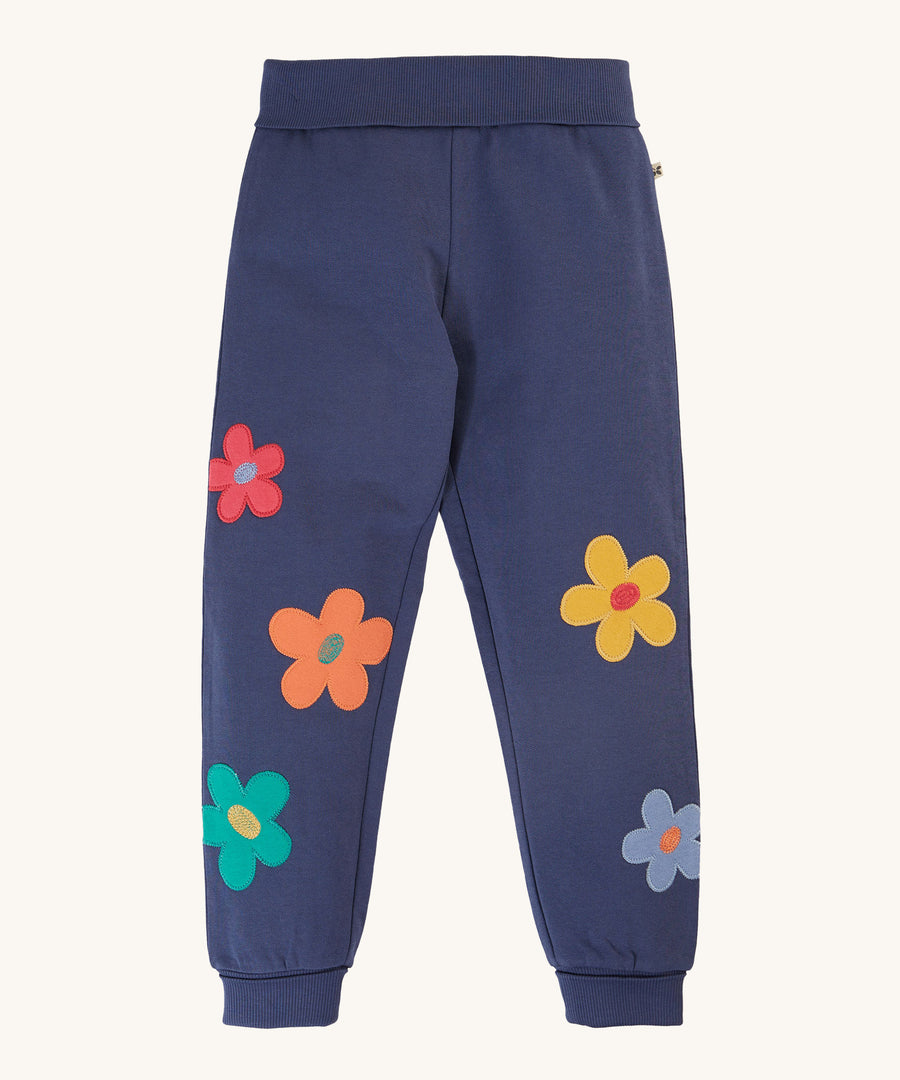 Frugi Perrin Parsnip Jogger - Navy Blue/Flowers. A navy blur fabric, with colourful flower appliques