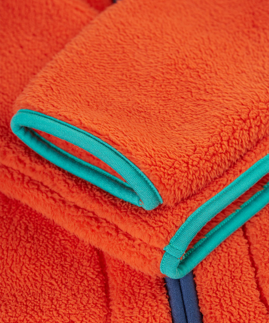 A closer look at the sleeves on the Frugi Toby Ted Fleece Jacket - Bonfire, showing the light blue piping