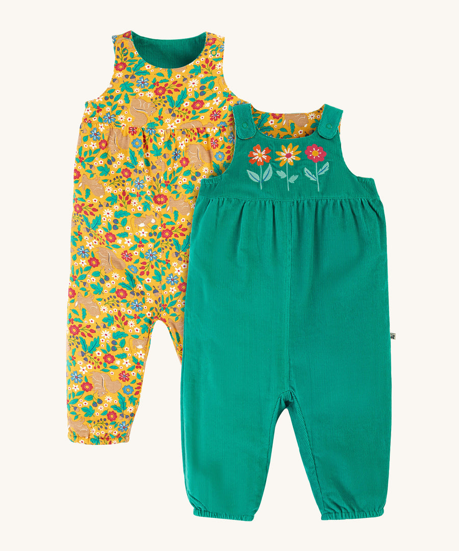 Frugi Lacey Reversible Dungaree - Iguana/Autumn Friends. One side is green with 3 flower appliques, and the other is a yellow floral and rabbit print