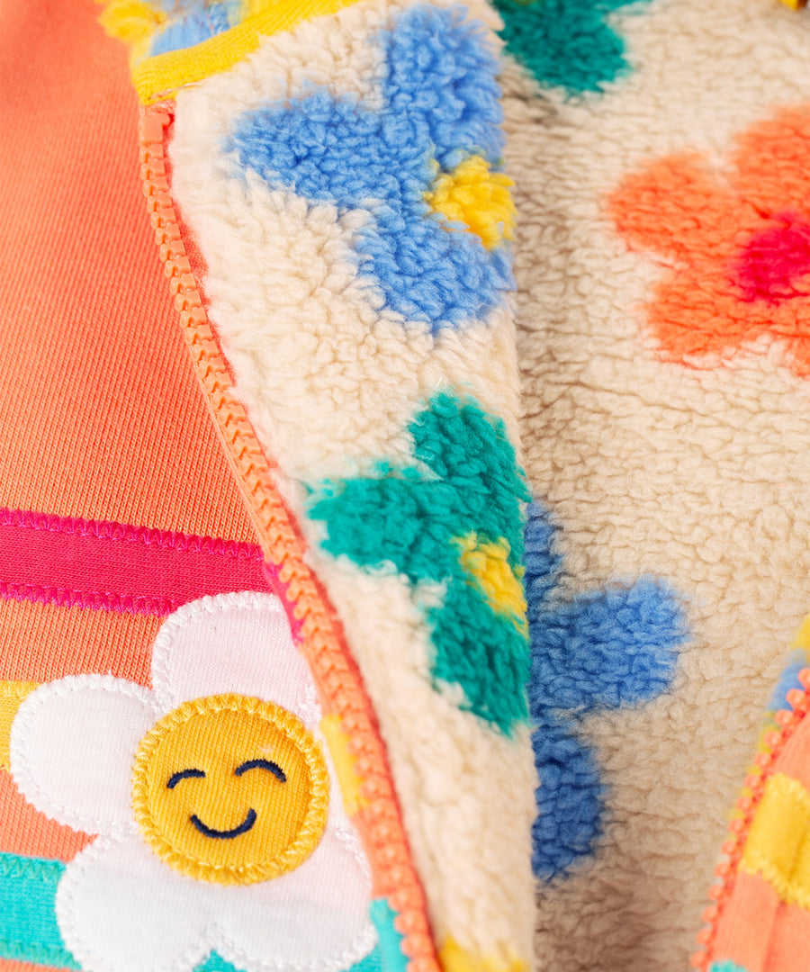 A closer look at the flower appliques, and flower pop fleece inside the Frugi Ted Fleece Lined Hoody - Cantaloupe/Rainbow