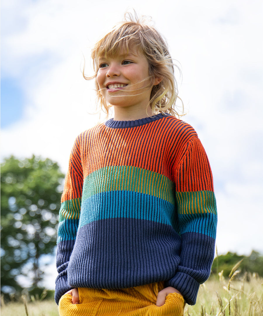 A child wearing the Frugi Top Notch Jumper - Navy Blue