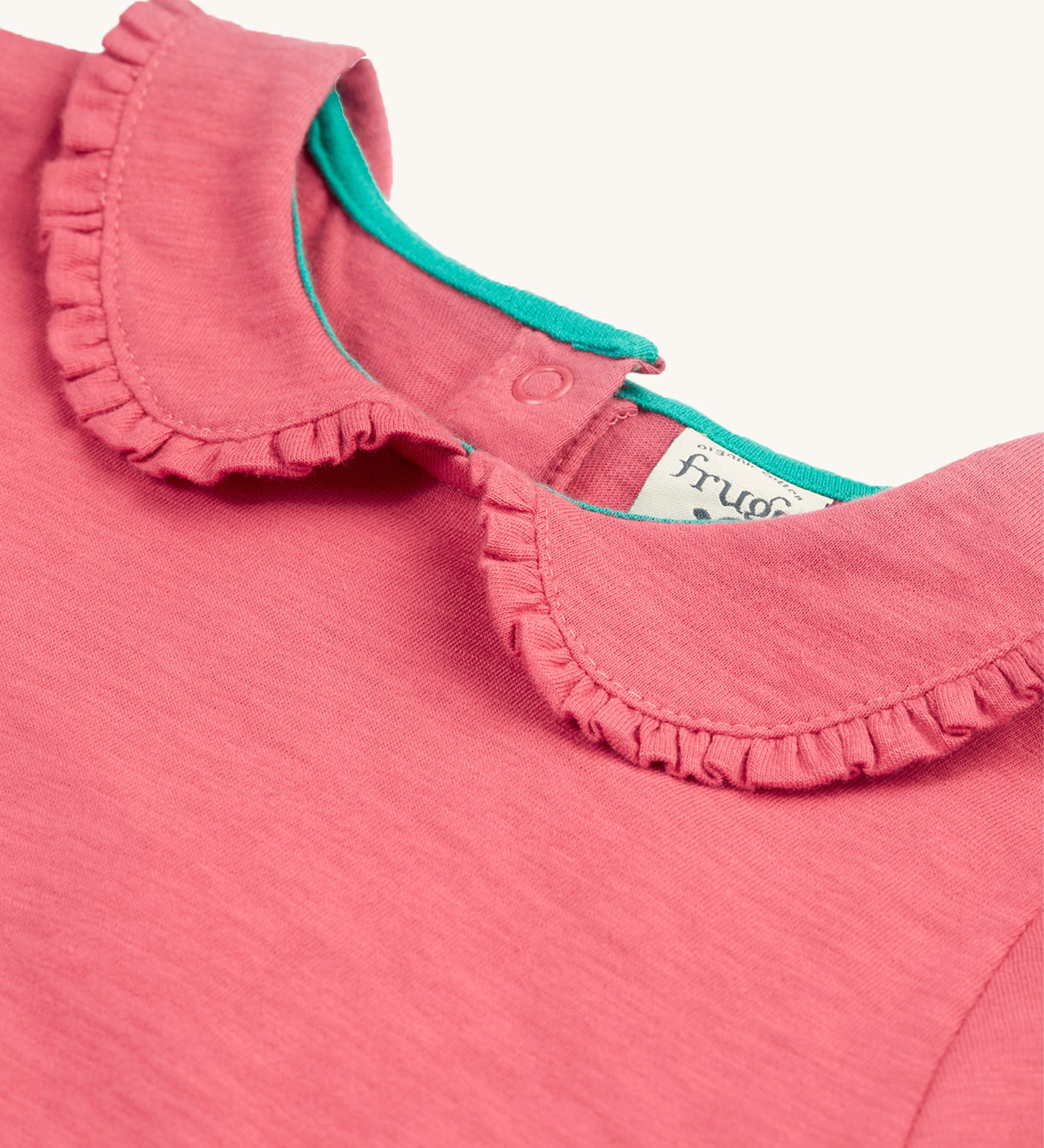 A closer look at the ruffled collar on the Frugi Victoria Collared Tunic Top - Petal/Cat