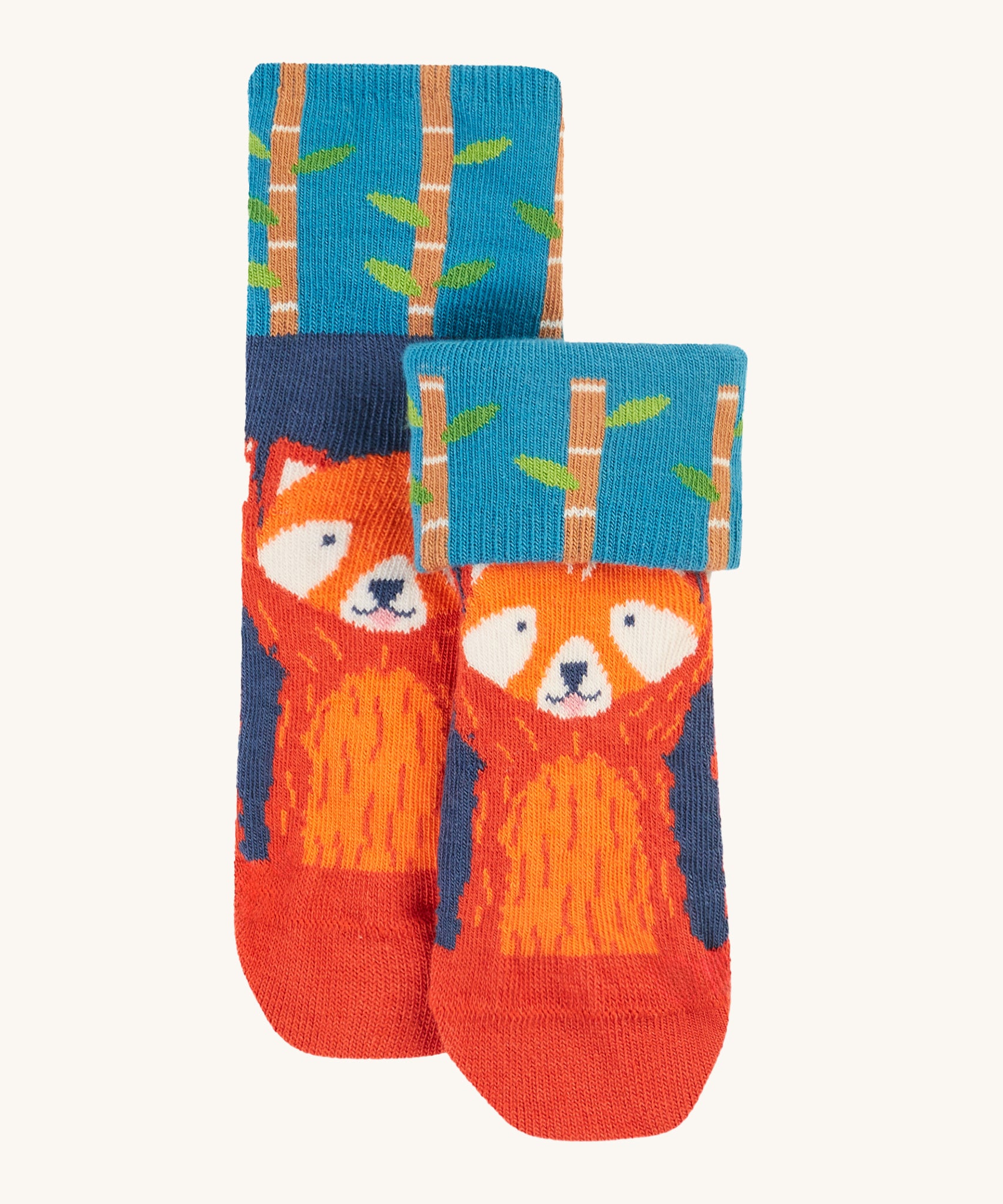 The red panda pair of socks from the Frugi Fun Fold Over Socks - Red Panda 2 Pack. Thes socks are blue, with a re panda on the front, and a bamboo fold over print