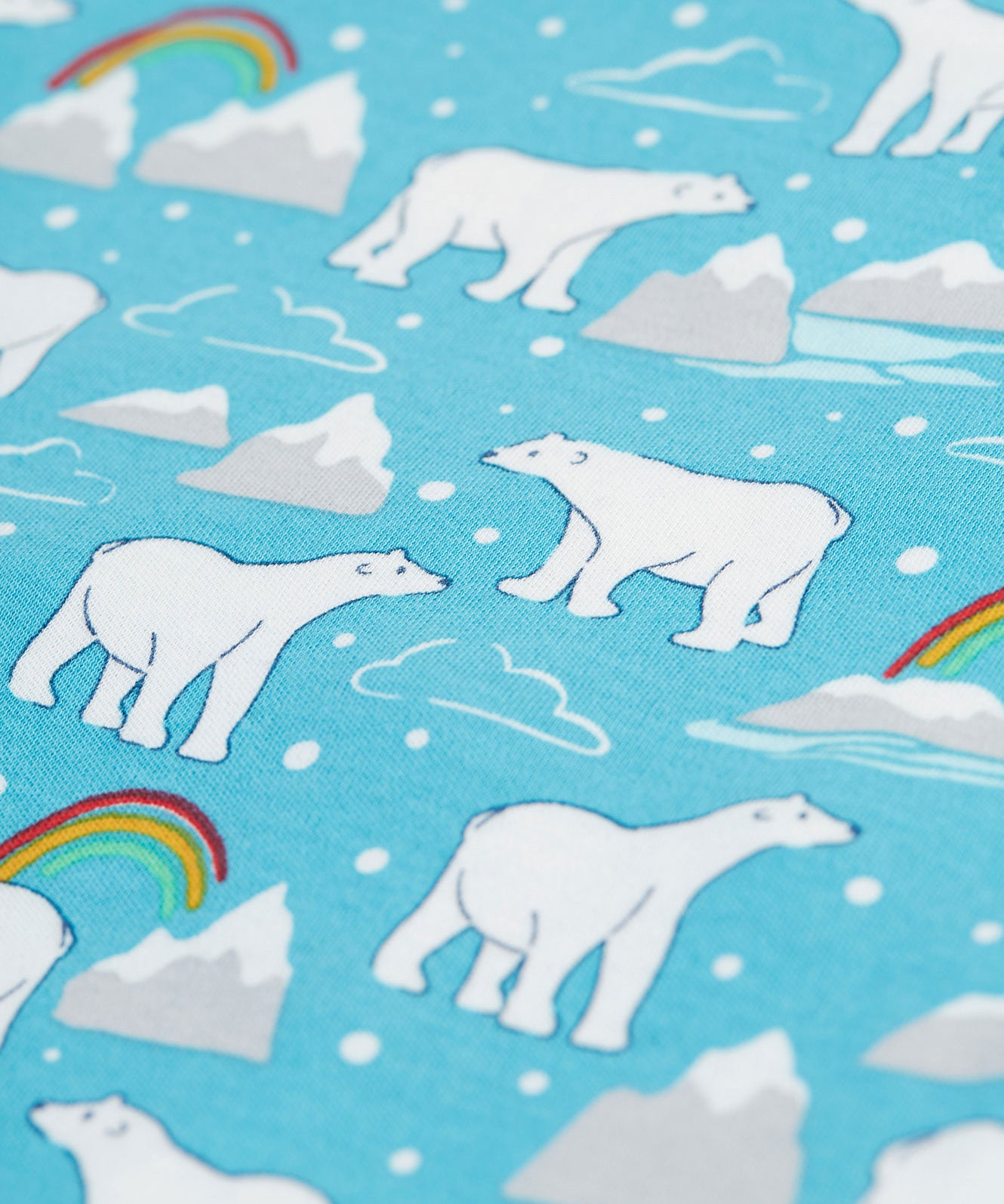 A close up of the Polar Bear, cloud, iceberg, and rainbow print on blue fabric, from the Frugi Easy Dressing Babygrow - Winter Tails