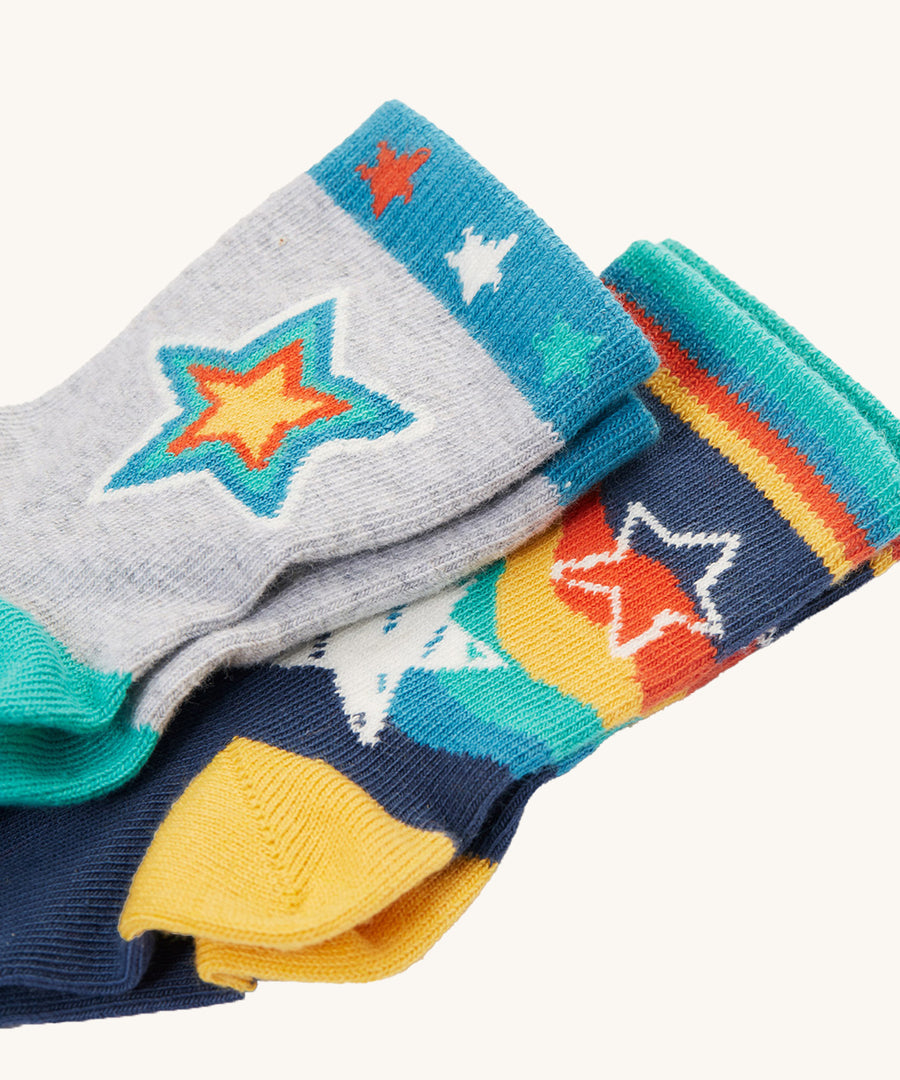 Both pairs of Frugi Little Socks - Stars 2 Pack. The grey pair is on top, with the navy pair below