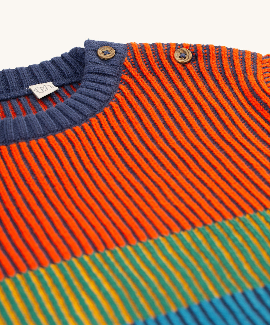 A closer look at the colourful knit pattern and buttons on the shoulder of the Frugi Top Notch Jumper - Navy Blue