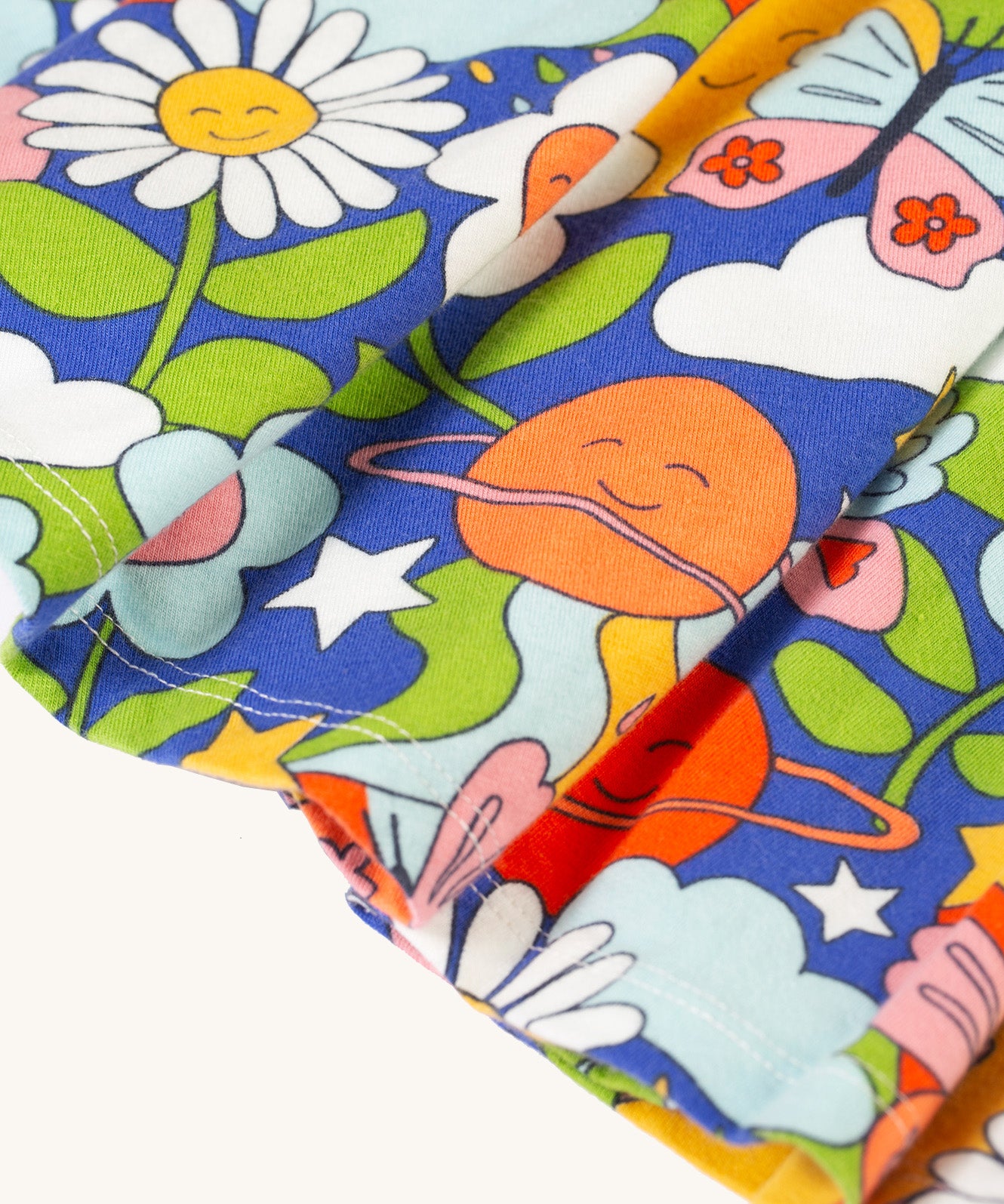 A closer look at the dress skirt and retro happy print on the Frugi Sofia Skater Dress - Retro Happy