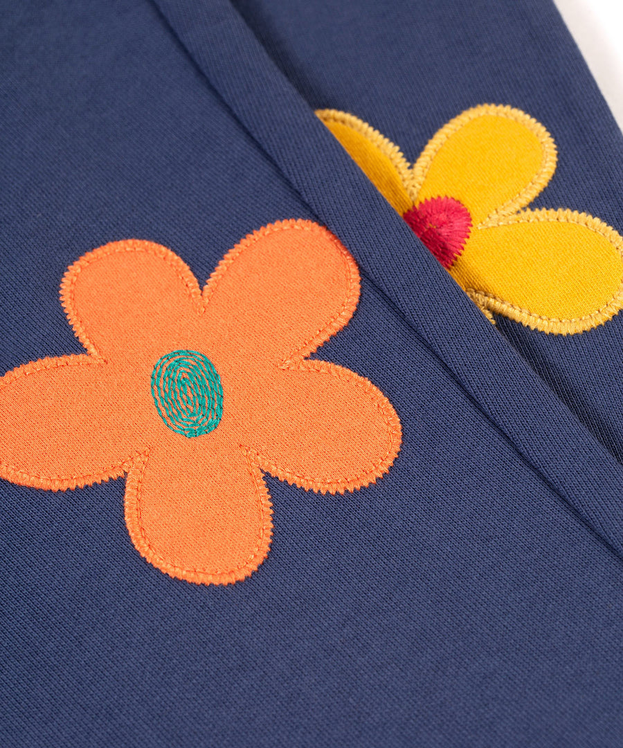 A closer look at the flower applique on the Frugi Perrin Parsnip Jogger - Navy Blue/Flowers