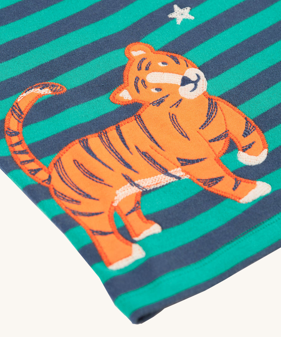 A closer look at the tiger applique on the Frugi Bobby Applique Top - Iguana Stripe/Tiger