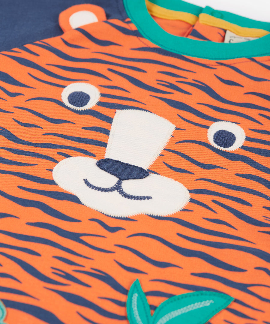 A closer look at the tiger face applique on the Frugi Happy Raglan Top - Tiger