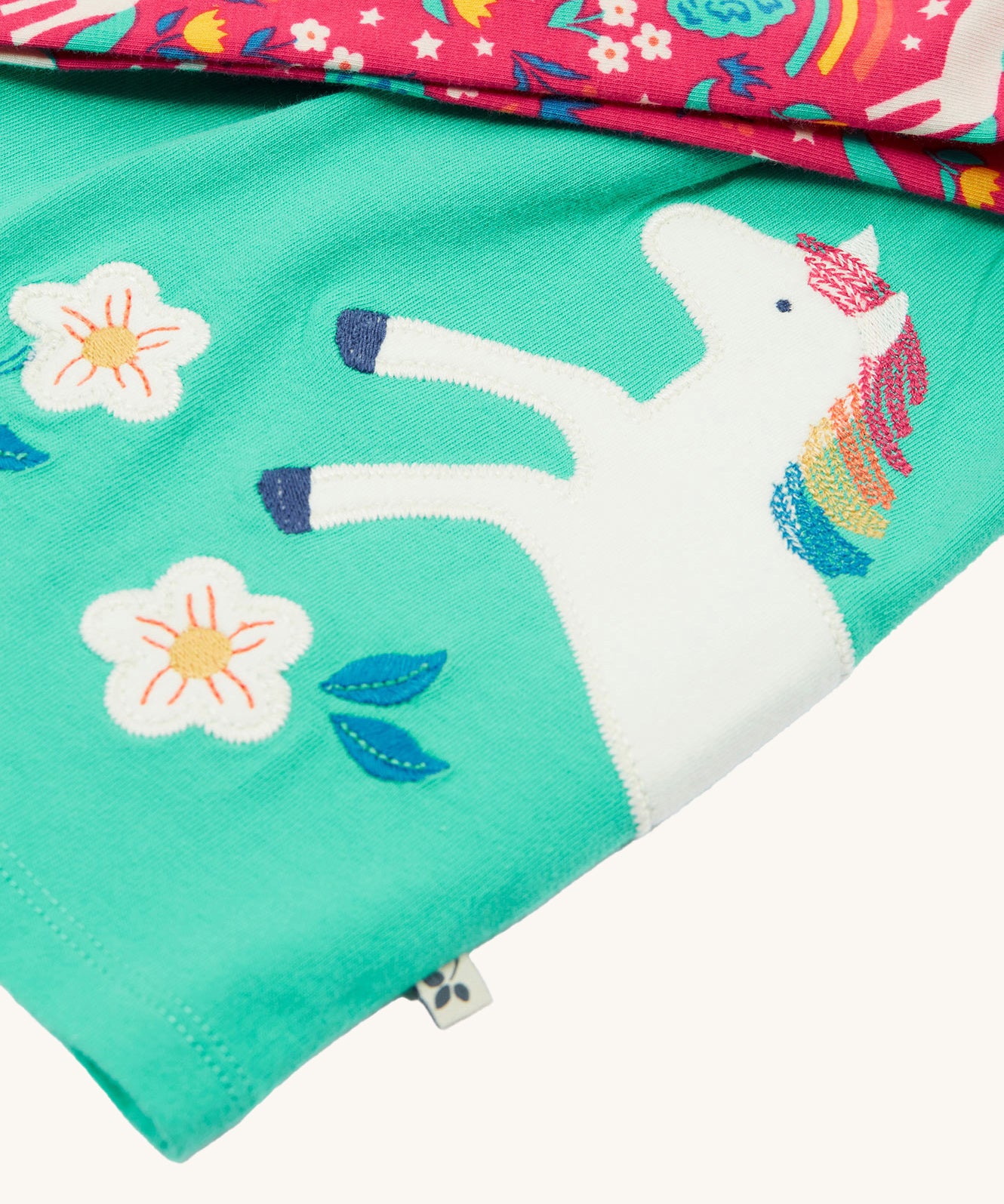 A closer look at the horse detail on the Frugi Tilly Outfit - Pacific Aqua/Wild Horses