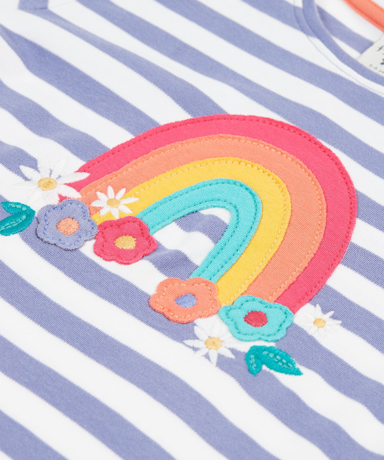 A closer look at the rainbow and flower applique on the Frugi Louise Applique Top - Grape Stripe/Rainbow. The rainbow arch lines are red, orange, yellow and light green, with flowers in the same colour