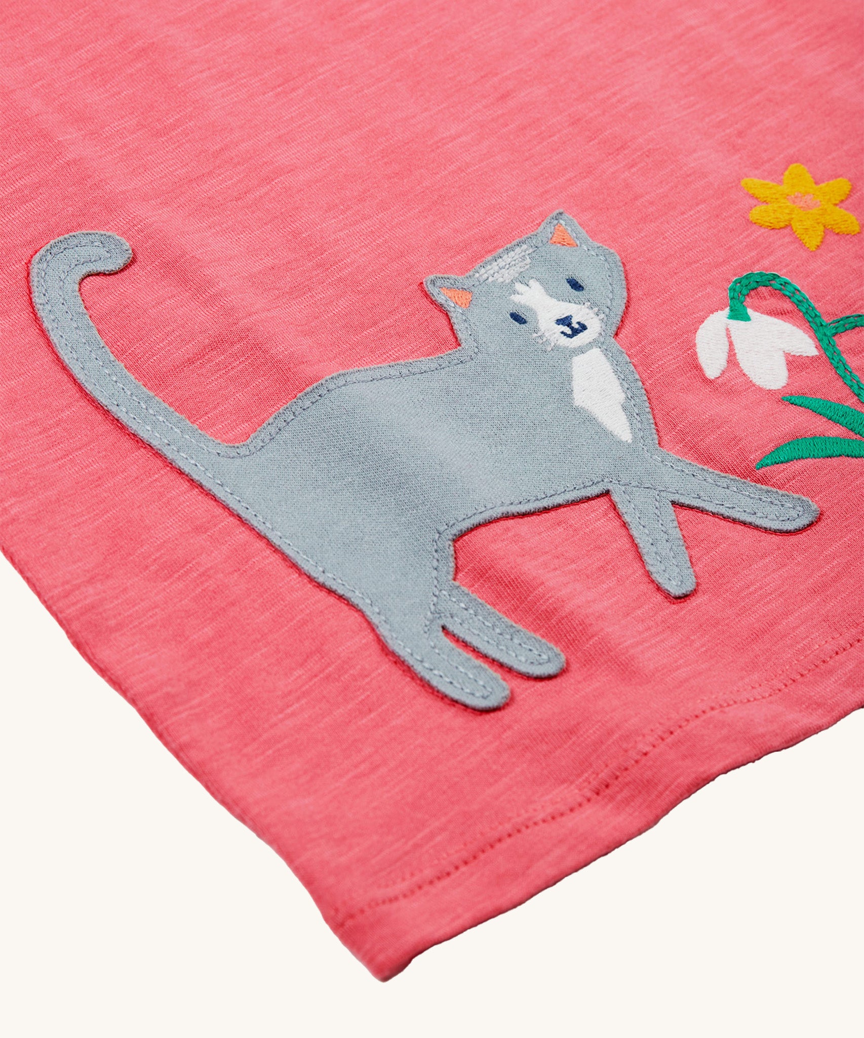 A closer look at the cat and flower patch on the Frugi Victoria Collared Tunic Top - Petal/Cat