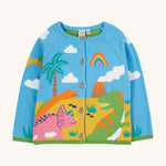 Frugi blue knitted cardigan dino design on a cream background.