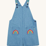 Frugi blue denim short dungarees rainbow design on a cream background.