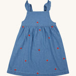 Frugi blue denim dress strawberry design on a cream background.