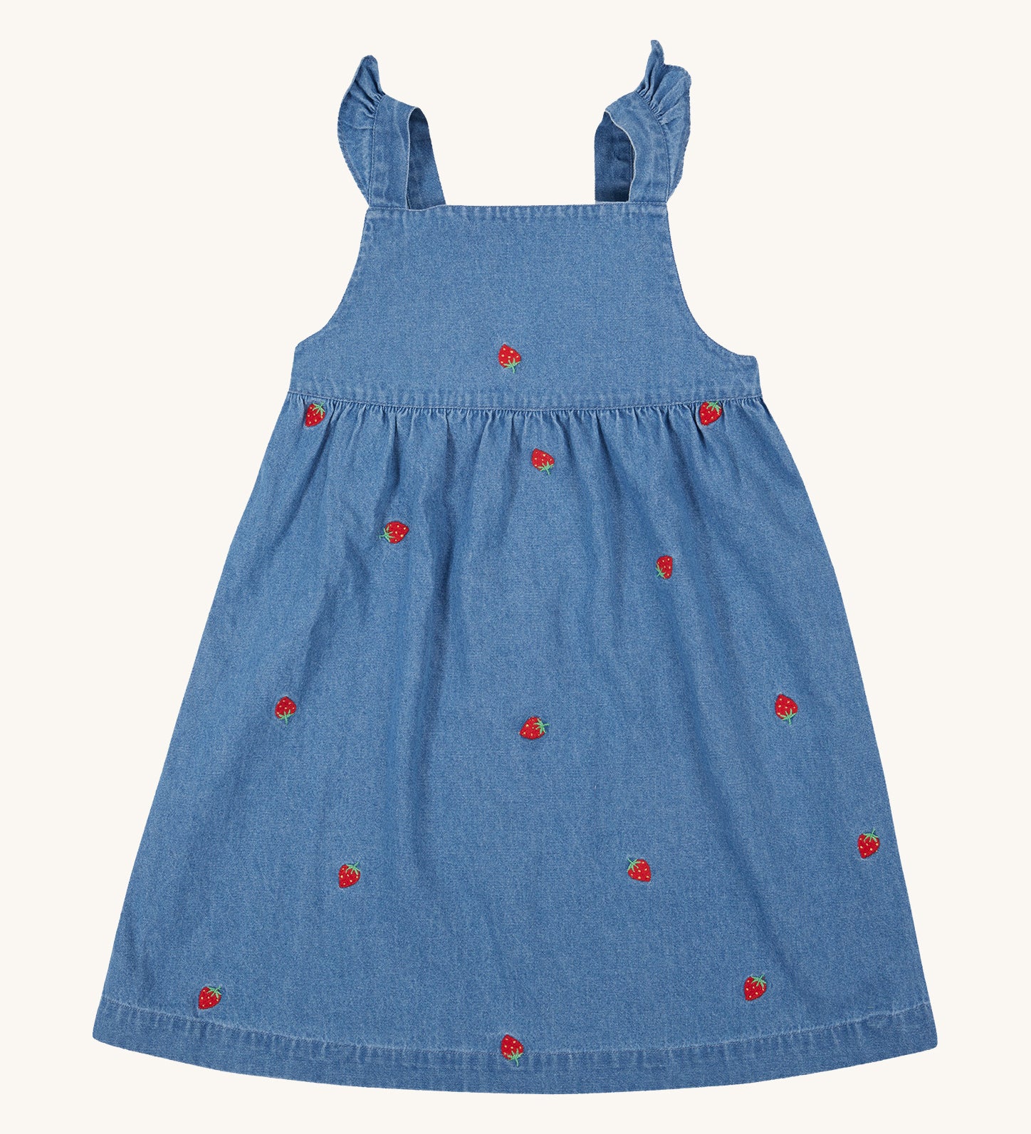 Frugi blue denim dress strawberry design on a cream background.