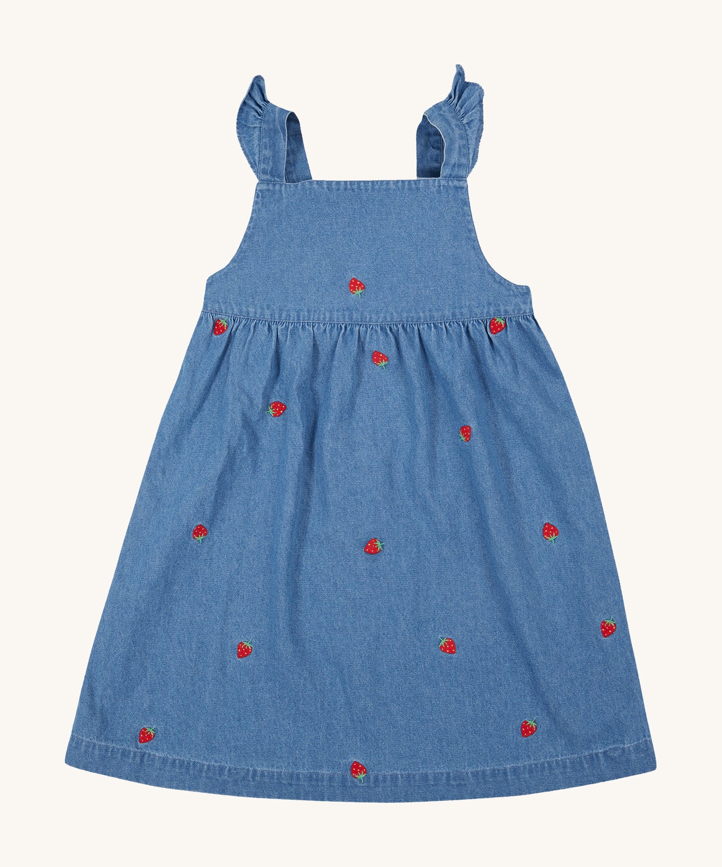 Frugi blue denim dress strawberry design on a cream background.