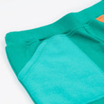 Frugi green joggers with a blue, orange yellow and green colour block design waist detail