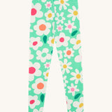 Frugi green leggings daisy design on a cream background.