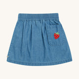 Frugi kids denim skirt with a flower, rainbow and strawberry design  back pocket detail