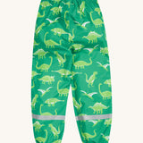 Frugi green rain and shine trousers dino roar design on a cream background.