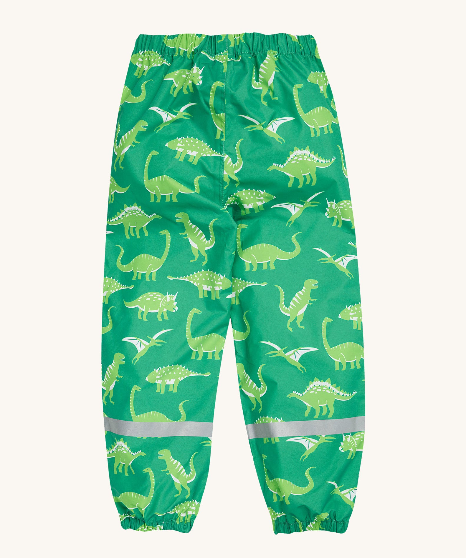 Frugi green rain and shine trousers dino roar design on a cream background.